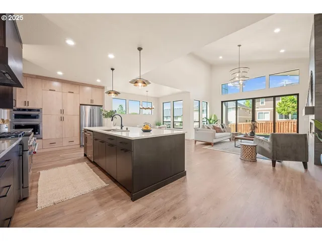 a kitchen with counter top space a sink stainless steel appliances and cabinets