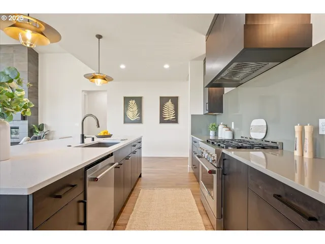 a view of a kitchen with white cabinets and wooden floor