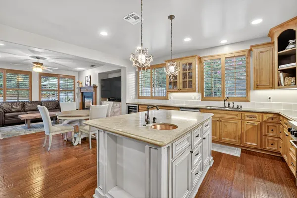 a kitchen that has a table chairs stove and cabinets