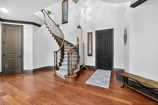 a view of an empty room with stairs and a window