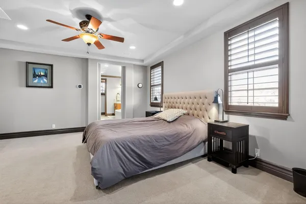 a bedroom with a bed and a chandelier