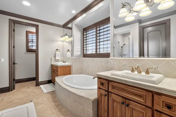 a bathroom with a sink a large mirror and a bathtub