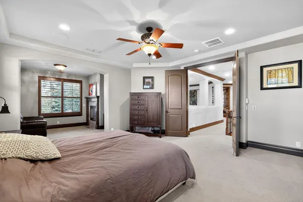 a bedroom with a large bed couch and window