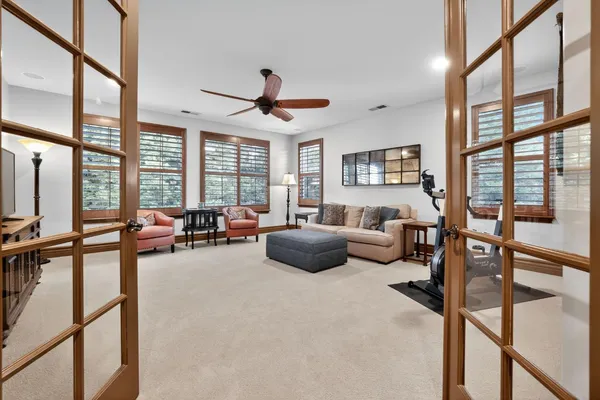 a bedroom with furniture and a large window