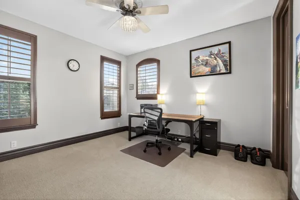 a view of a workspace with furniture and a window