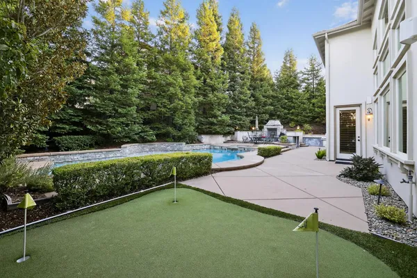 a view of backyard with seating area and green space