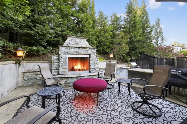 a outdoor space with chairs and a fireplace