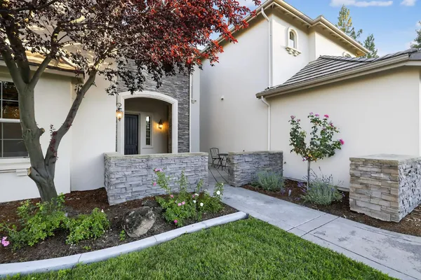 a front view of a house with garden