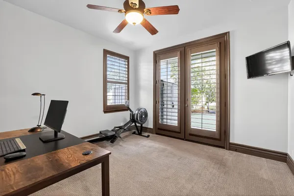 a view of a workspace with furniture and a window