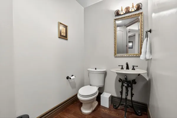 a bathroom with a toilet a sink and mirror