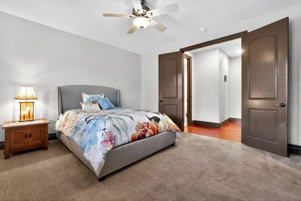 a spacious bedroom with a bed and a chandelier