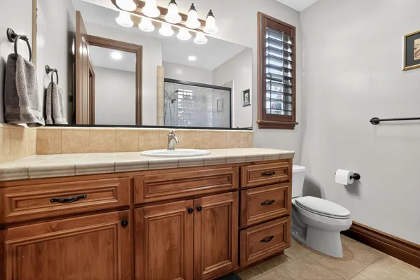 a bathroom with a sink a toilet and a mirror