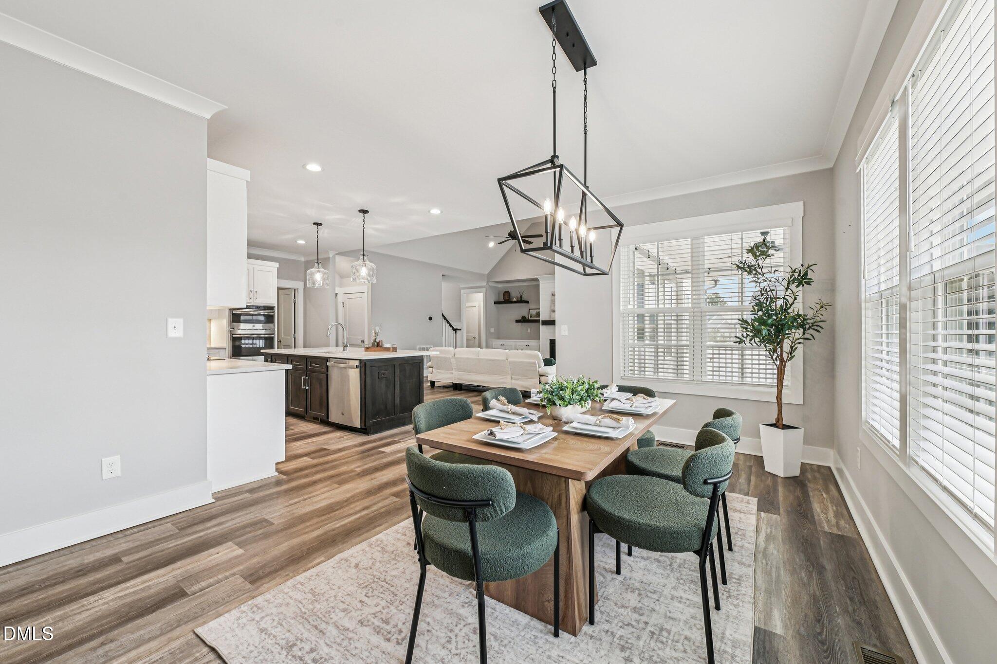 55 Dolores Court Willow Spring, NC 27592 - Photo 10 of 64 a view of a dining room and livingroom with furniture wooden floor a chandelier