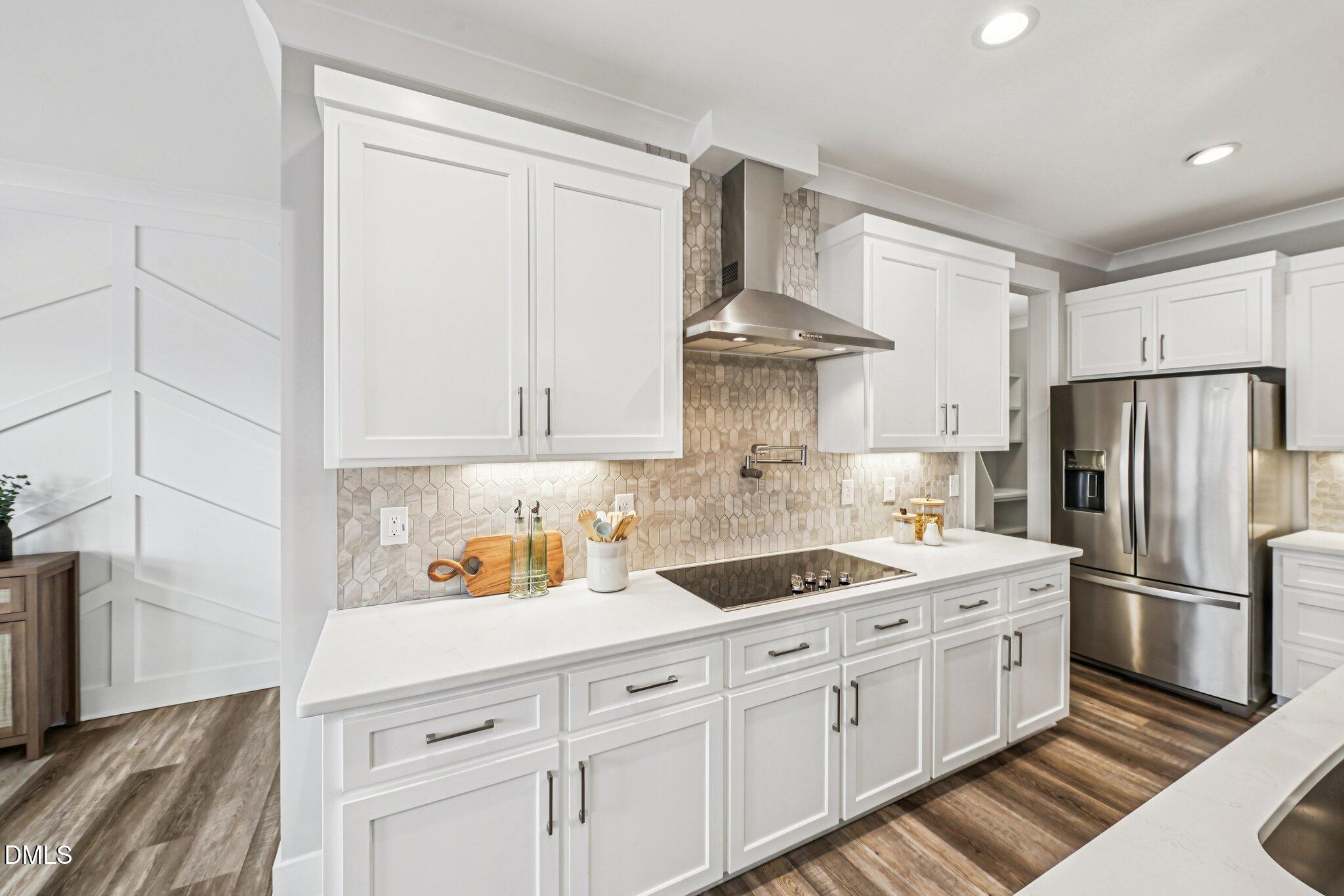 55 Dolores Court Willow Spring, NC 27592 - Photo 14 of 64 a kitchen with stainless steel appliances granite countertop a sink a stove and refrigerator