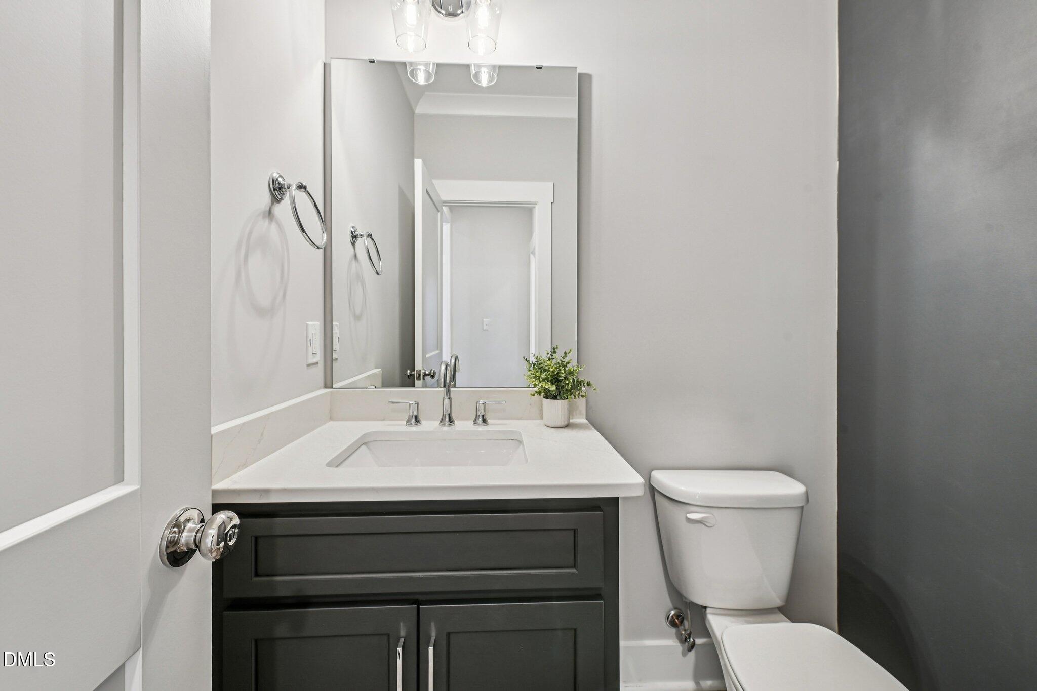 55 Dolores Court Willow Spring, NC 27592 - Photo 22 of 64 a bathroom with a sink toilet and mirror