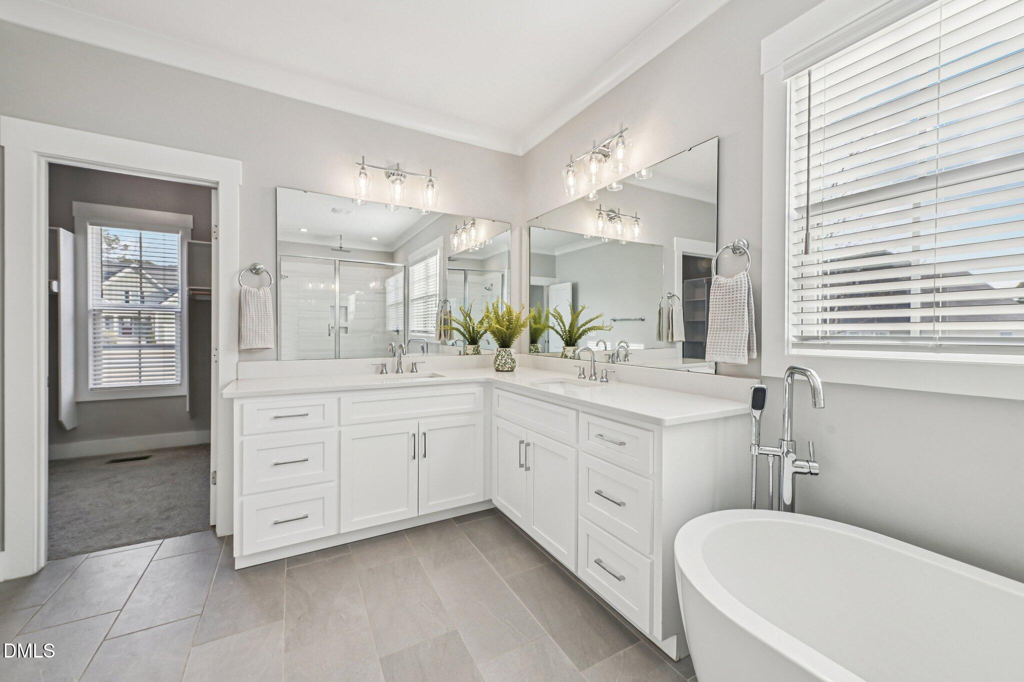 55 Dolores Court Willow Spring, NC 27592 - Photo 26 of 64 a spacious bathroom with a granite countertop sink mirror and bathtub