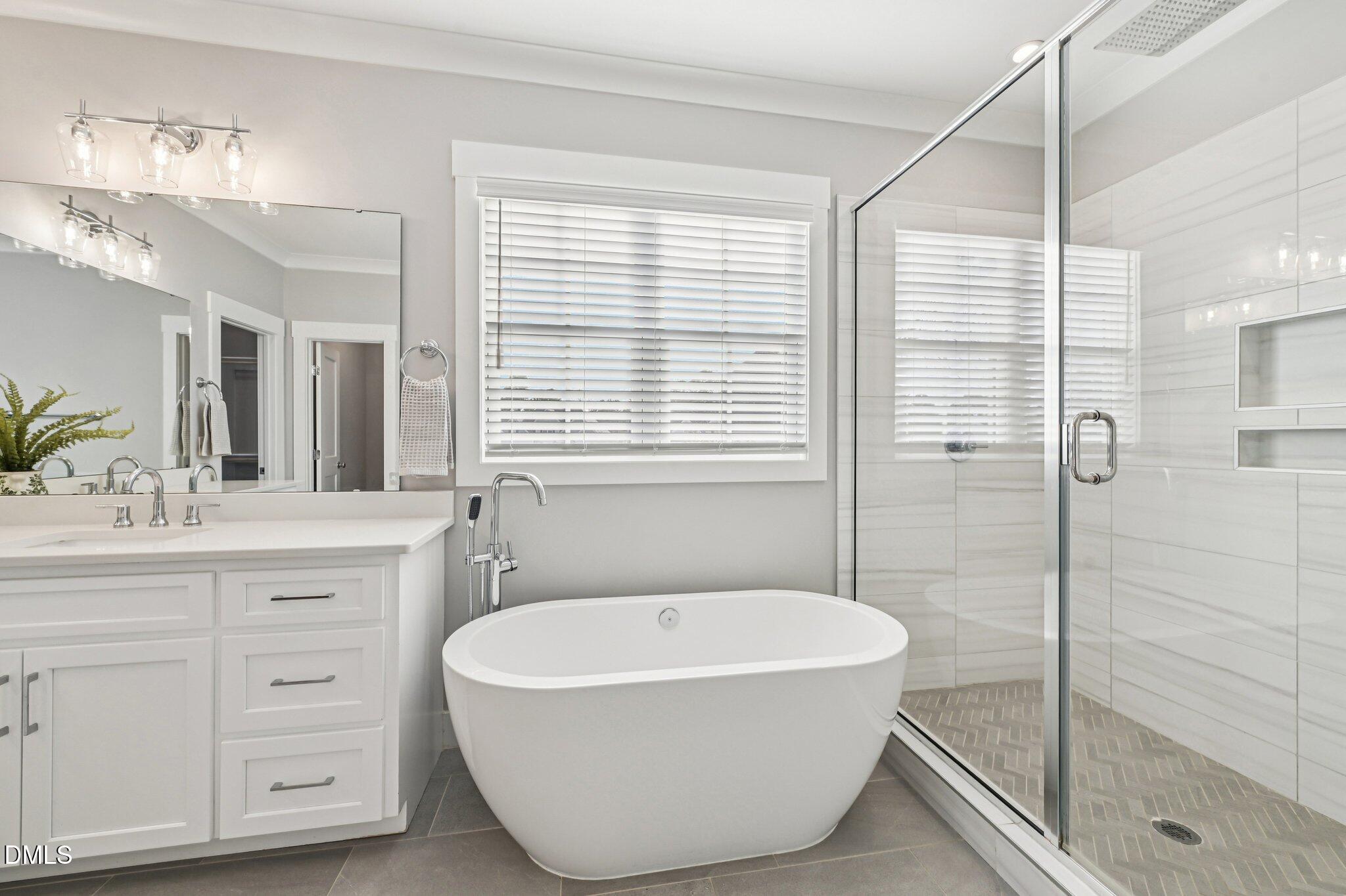 55 Dolores Court Willow Spring, NC 27592 - Photo 28 of 64 a bathroom with a tub a sink and a shower