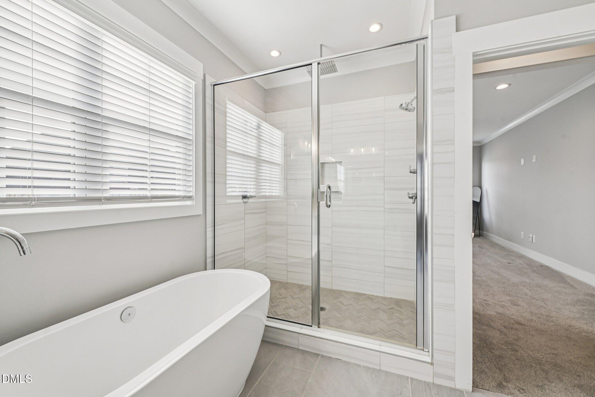 55 Dolores Court Willow Spring, NC 27592 - Photo 29 of 64 a bathroom with a bathtub and a shower