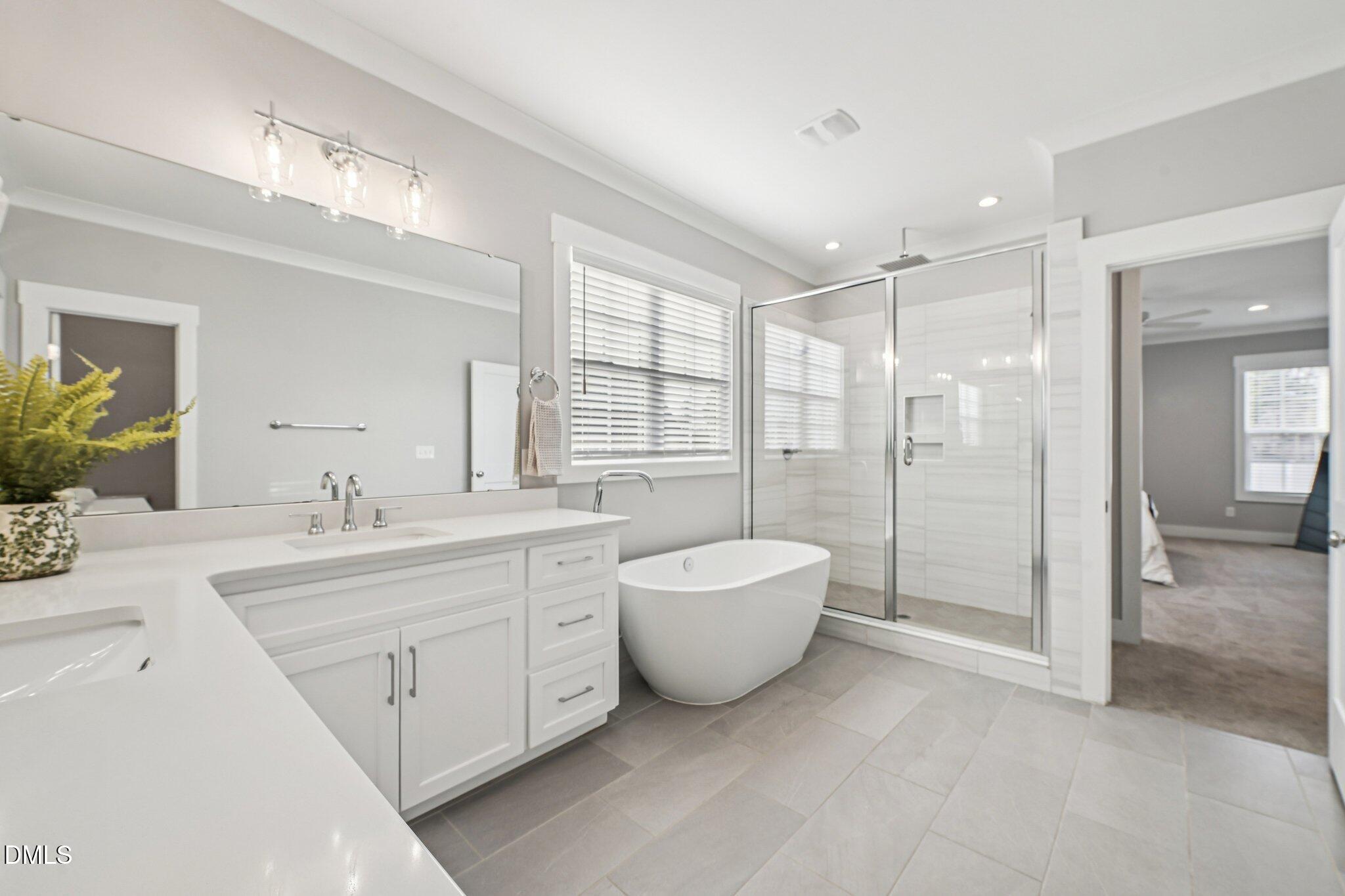 55 Dolores Court Willow Spring, NC 27592 - Photo 30 of 64 a spacious bathroom with a double vanity sink toilet mirror and bathtub