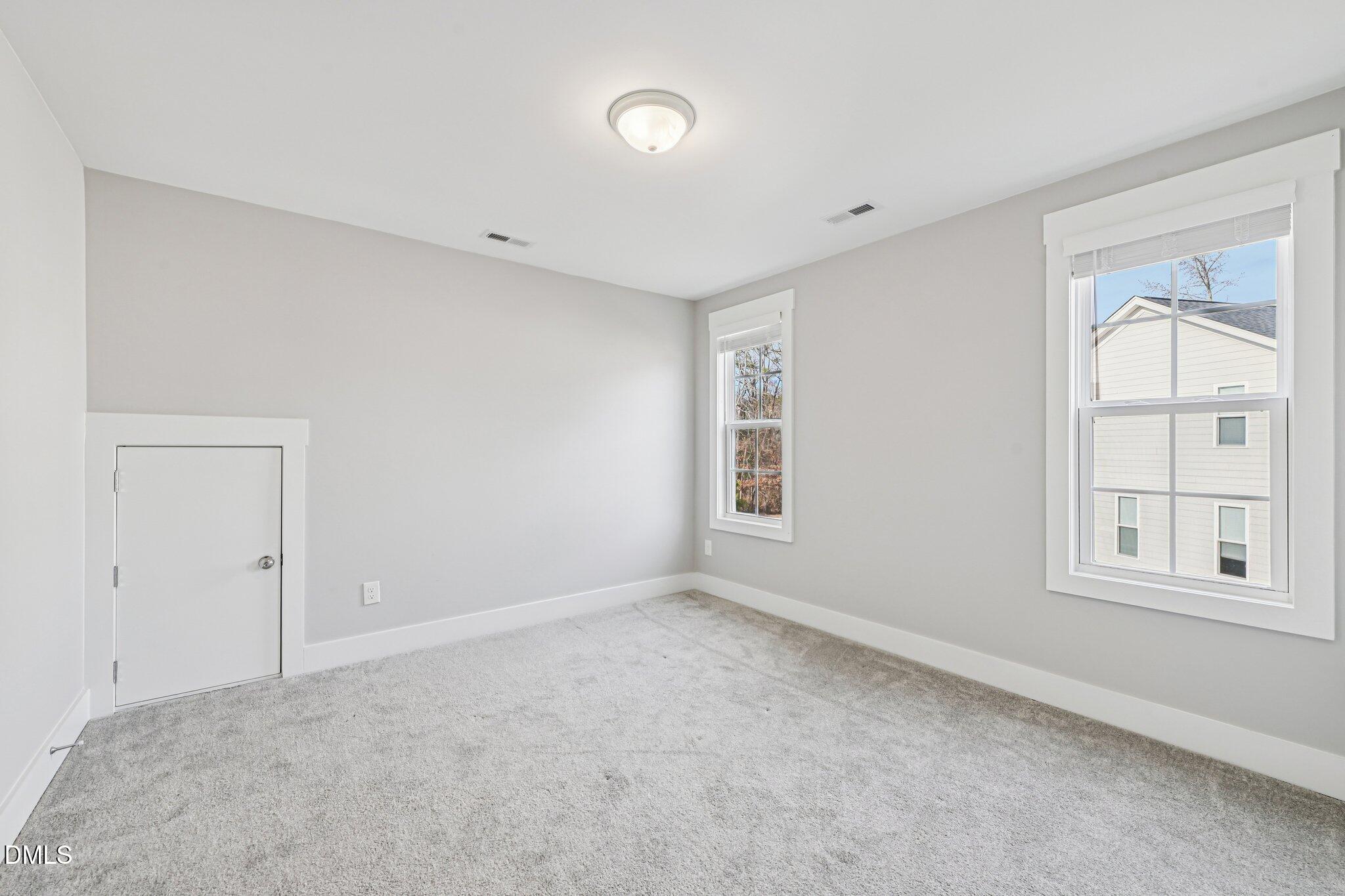 55 Dolores Court Willow Spring, NC 27592 - Photo 37 of 64 an empty room with windows and closet