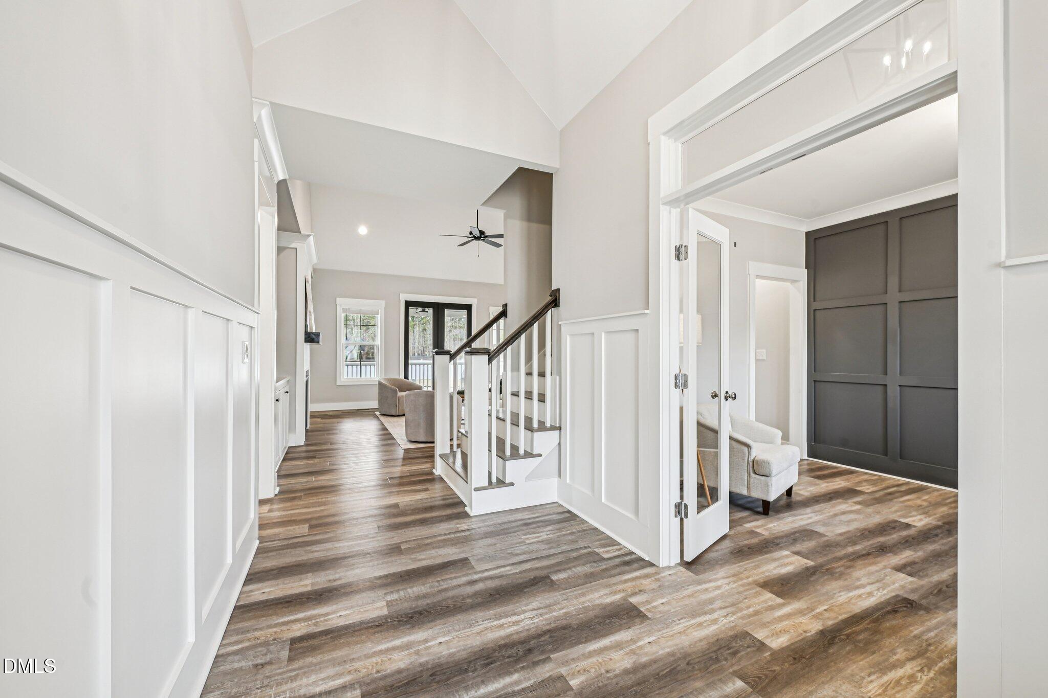 55 Dolores Court Willow Spring, NC 27592 - Photo 4 of 64 a view of a hallway with wooden floor and staircase