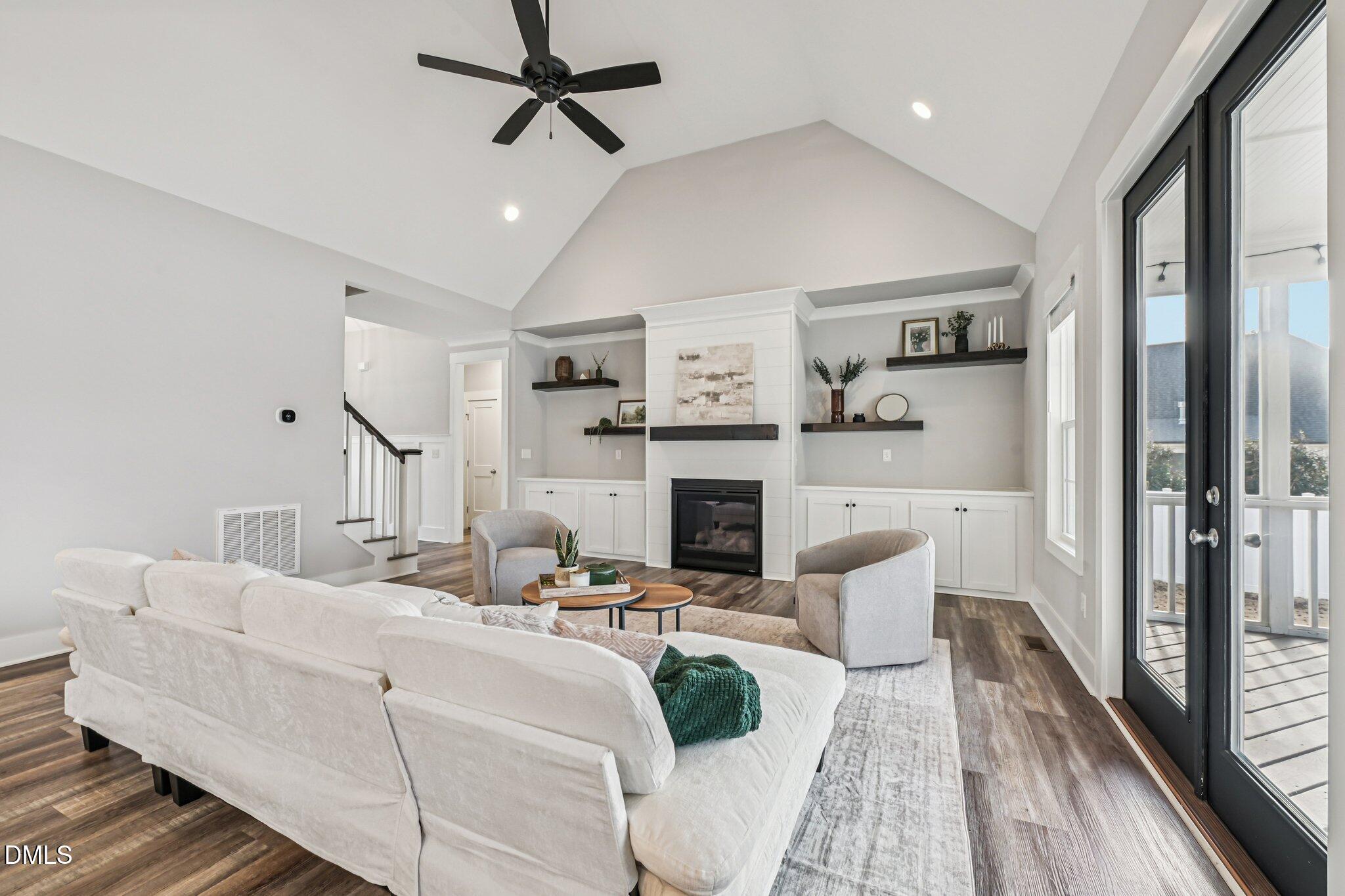 55 Dolores Court Willow Spring, NC 27592 - Photo 7 of 64 a living room with furniture fireplace and a large window