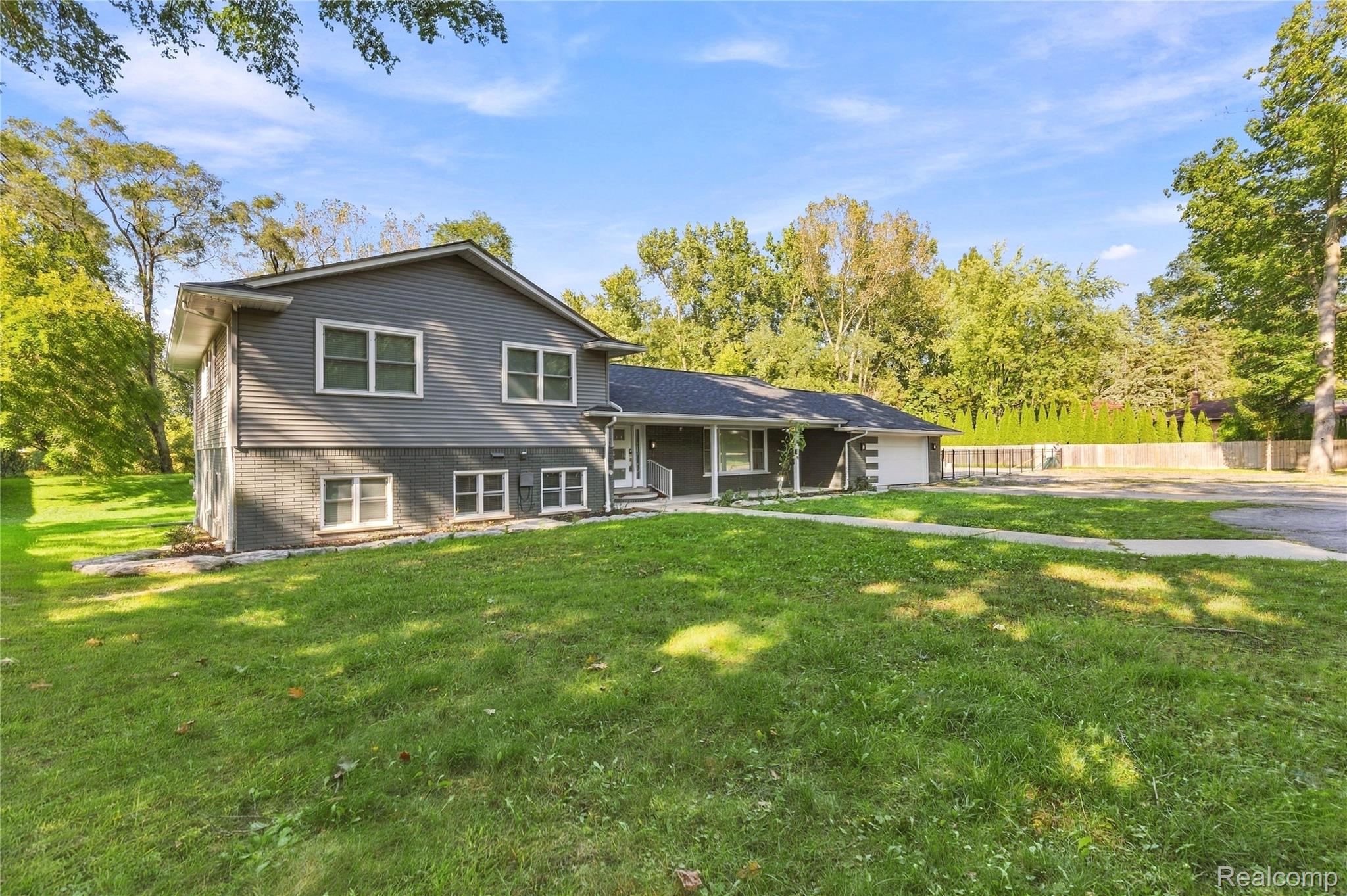 15879 Millar Road Clinton Township, MI 48036 - Photo 44 of 65 Modern two-story exterior with gray siding and brick accents