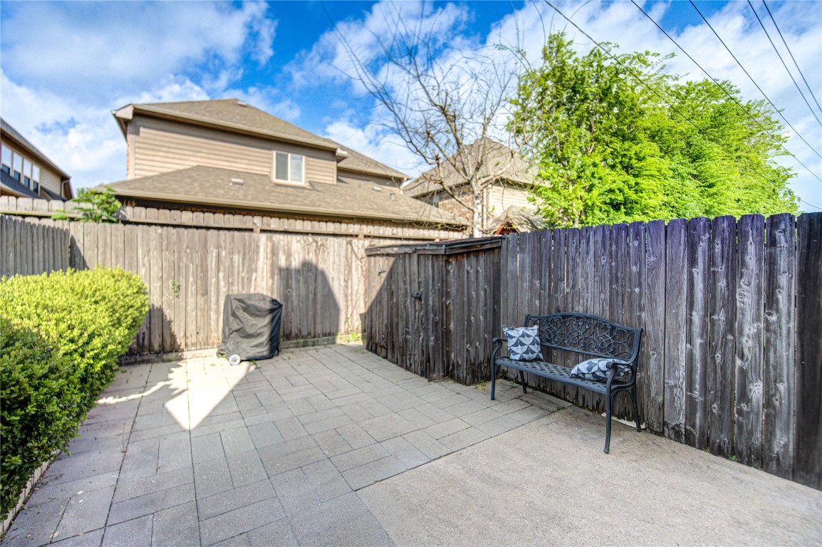 2002 Gentryside Drive, Unit 117 Houston, TX 77077 - Photo 27 of 31 a backyard of a house with chairs and a fire pit
