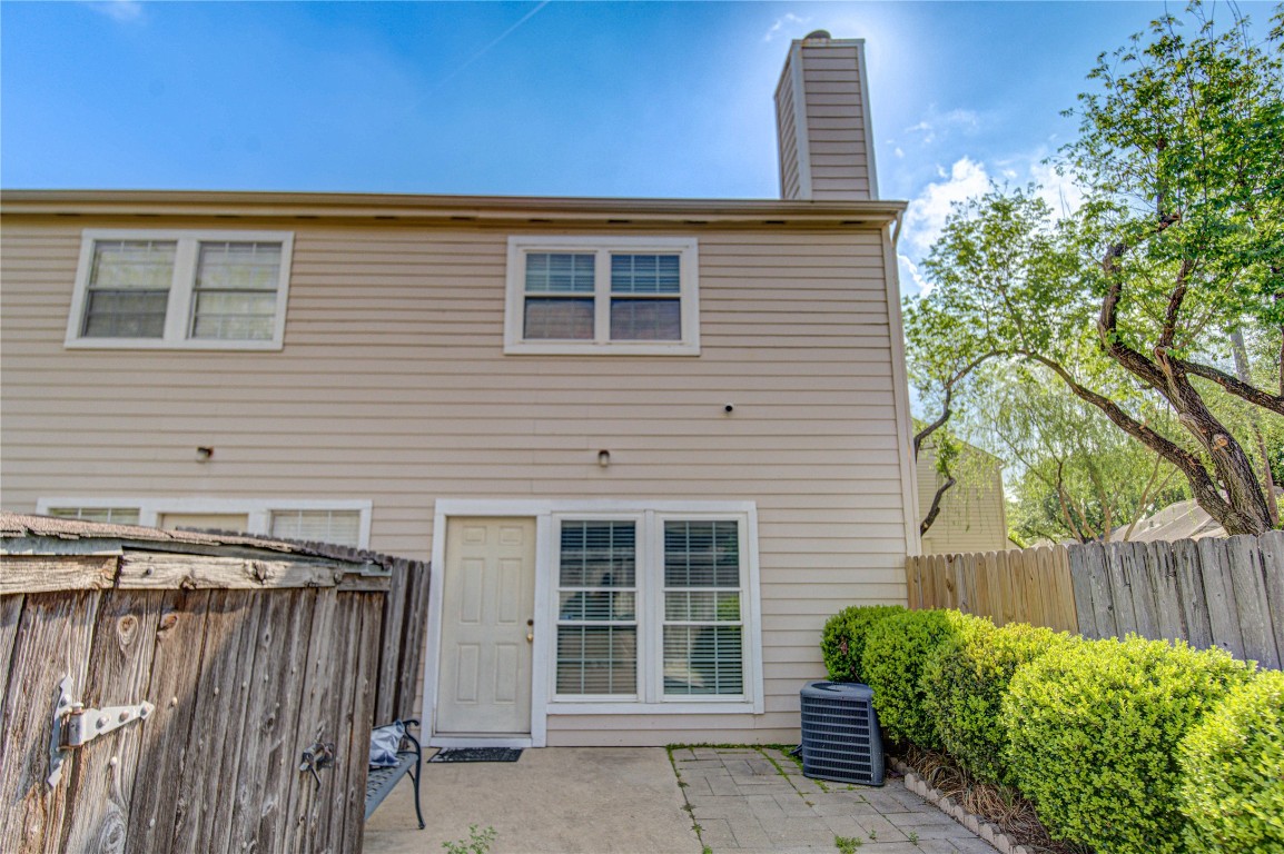 2002 Gentryside Drive, Unit 117 Houston, TX 77077 - Photo 30 of 31 a view of a house with a window and wooden fence