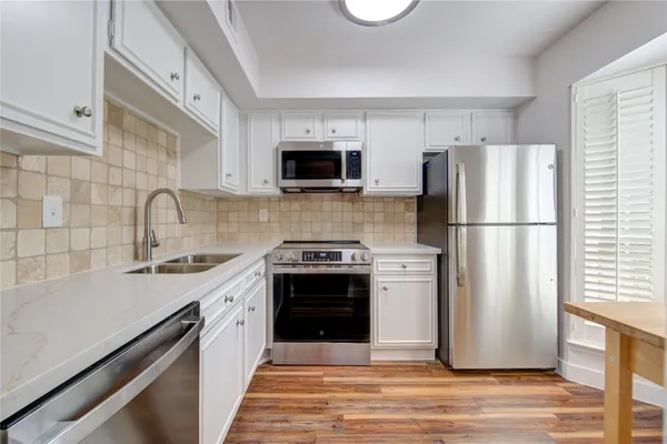 a kitchen with a refrigerator stove and sink