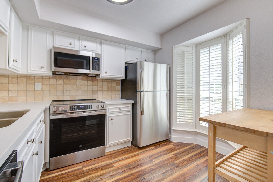 2002 Gentryside Drive, Unit 117 Houston, TX 77077 - Photo 4 of 31 a kitchen with a stove a refrigerator and a sink