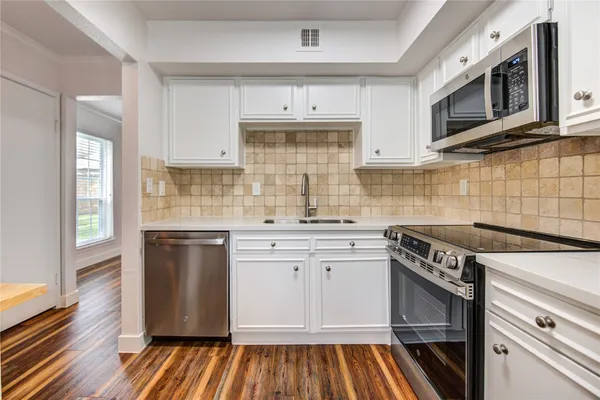 a kitchen with a sink stove and microwave