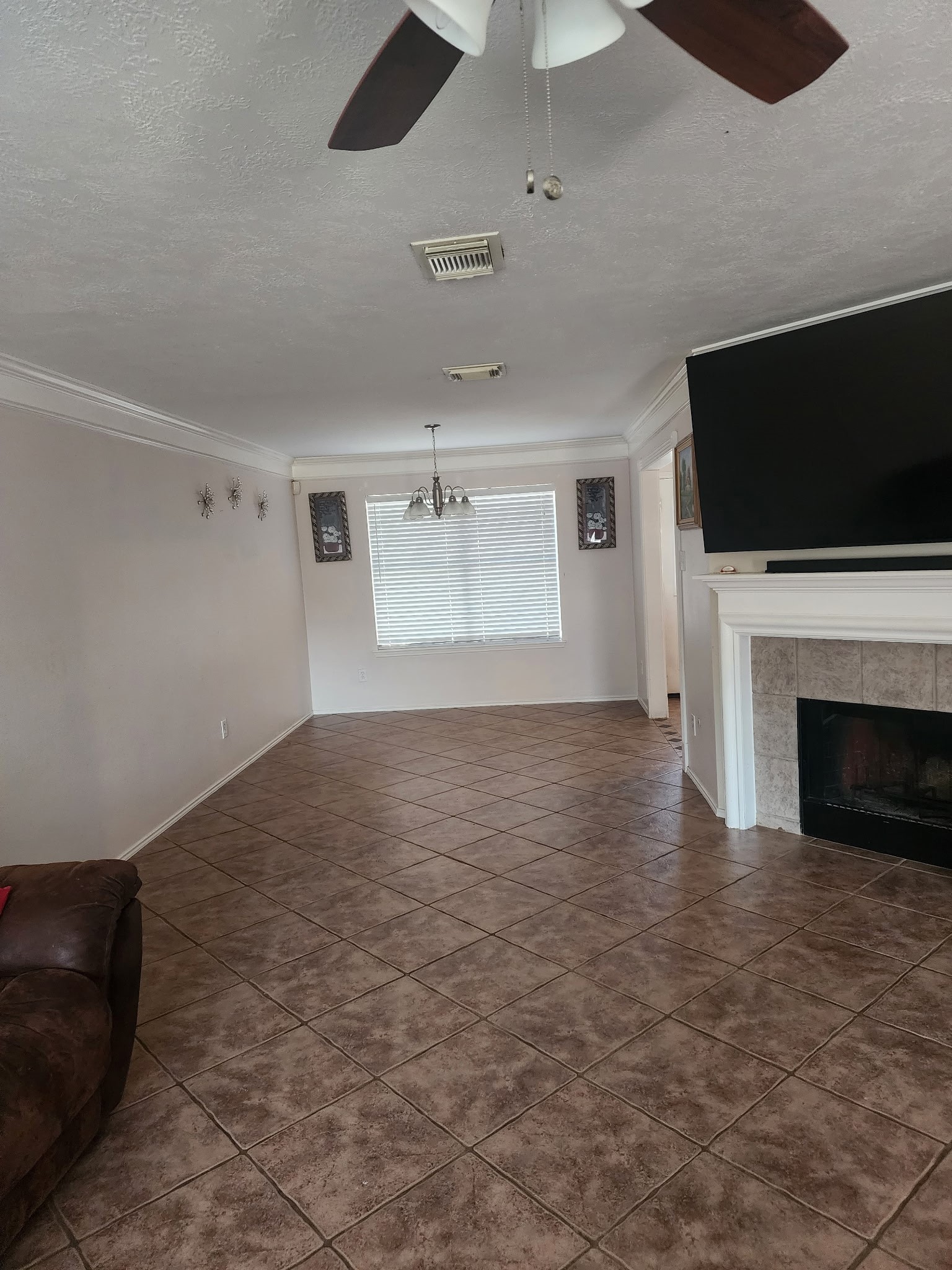 1530 Cartwright Road Missouri City, TX 77489 - Photo 3 of 23 a view of empty room with fireplace and flat screen tv