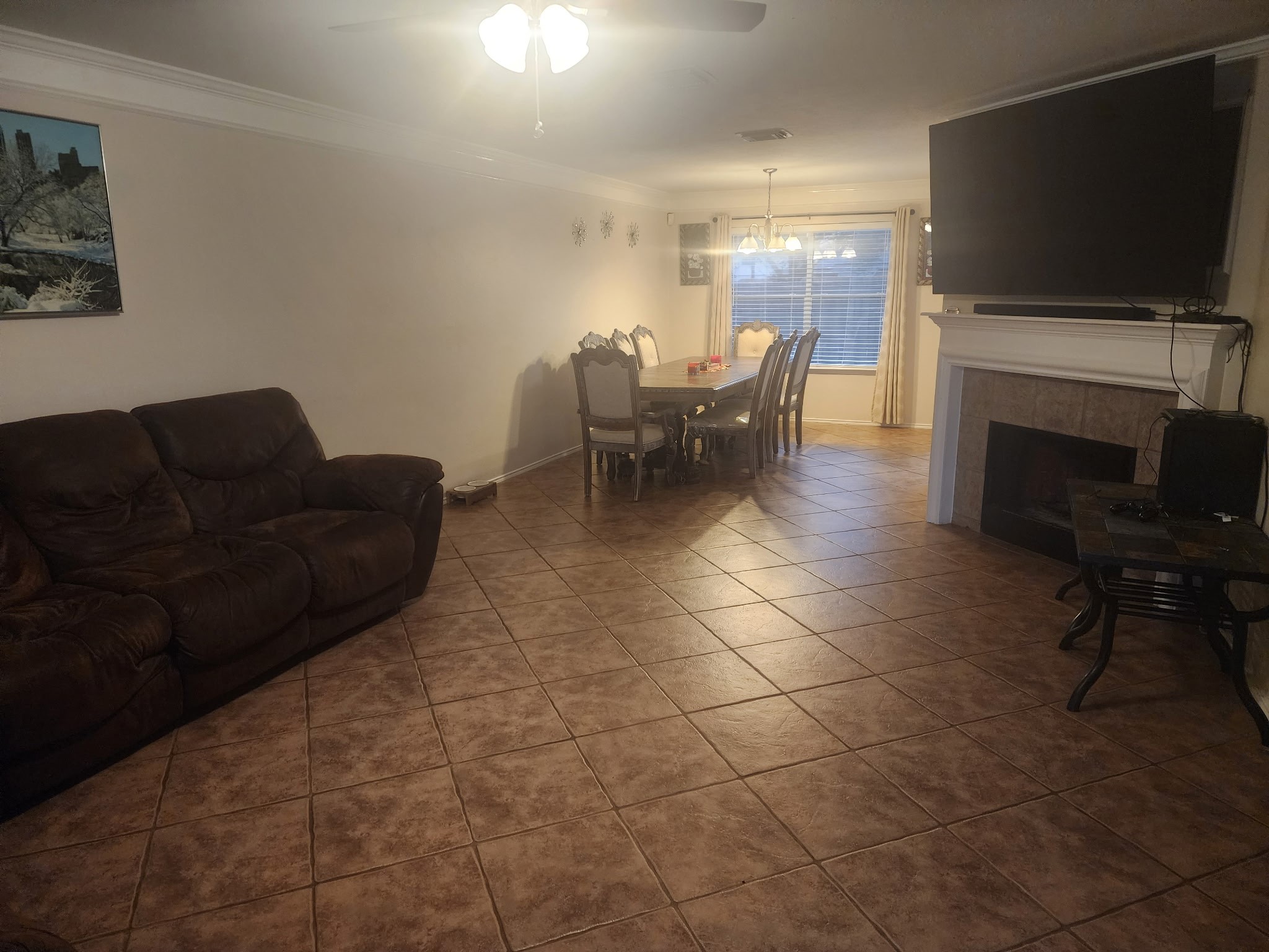 1530 Cartwright Road Missouri City, TX 77489 - Photo 6 of 23 a living room with furniture a flat screen tv and a fireplace