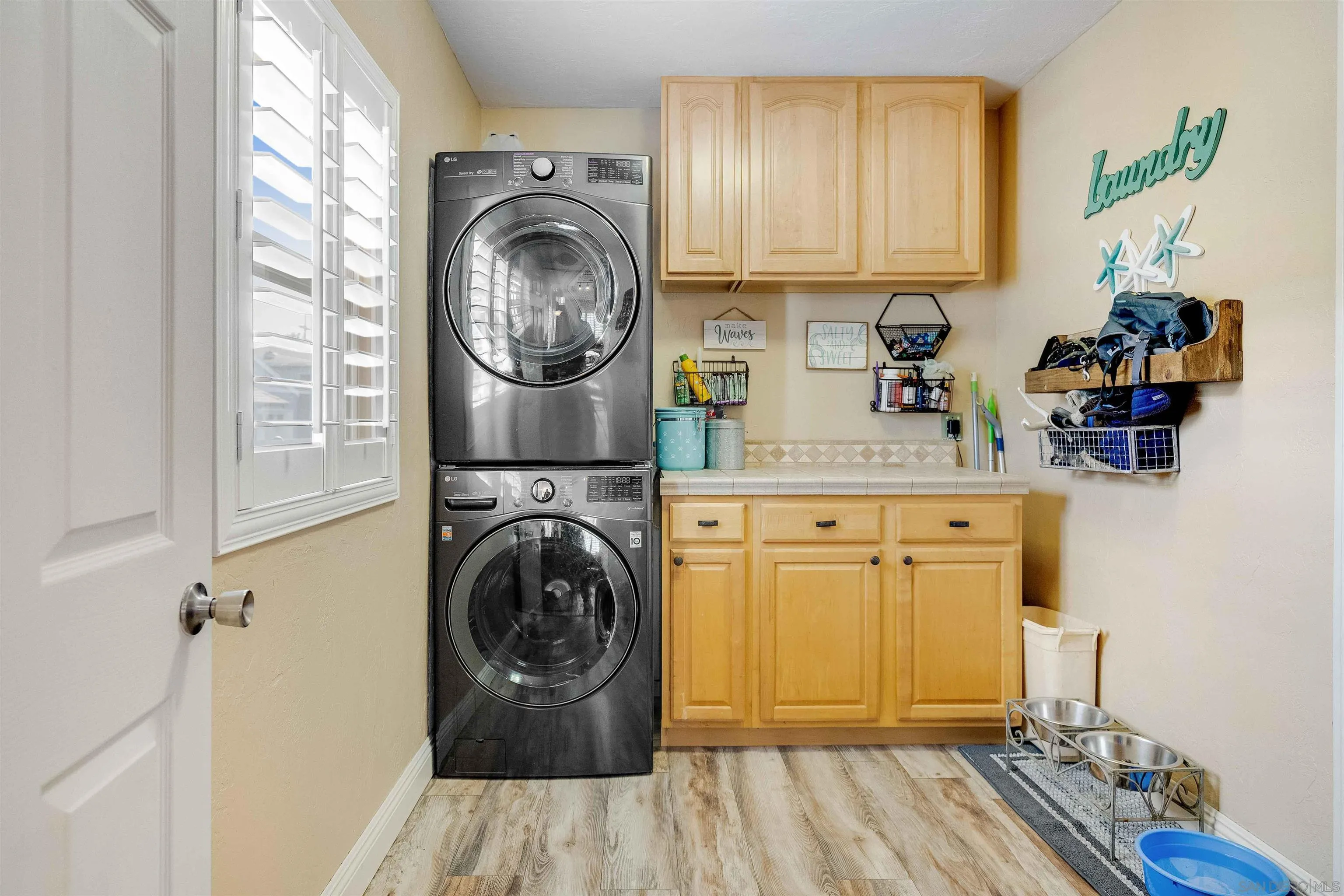 4516 Olive Avenue La Mesa, CA 91942 - Photo 14 of 48 a close view of a utility room with sink dryer and washer
