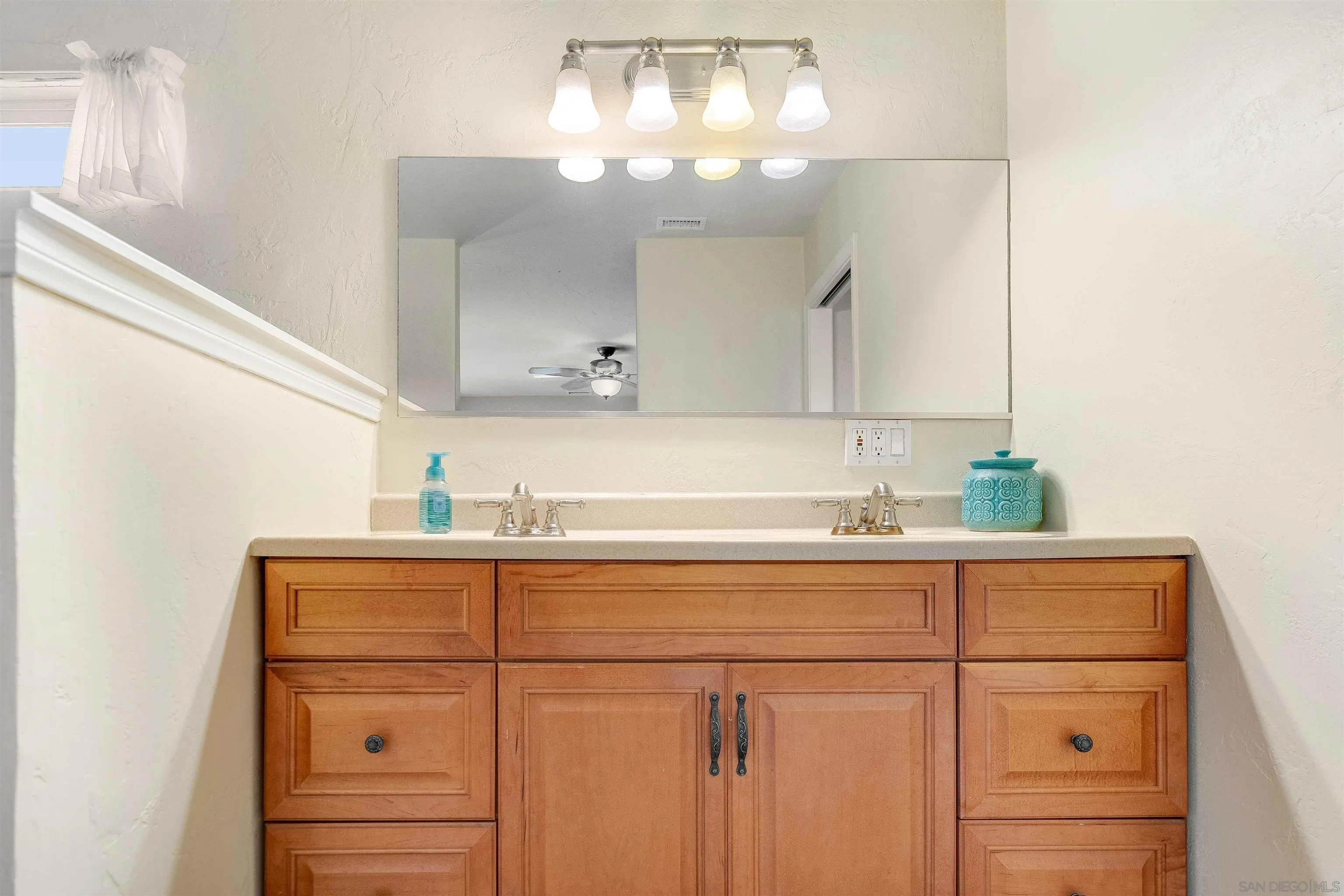 4516 Olive Avenue La Mesa, CA 91942 - Photo 23 of 48 a bathroom with a sink a vanity and mirror