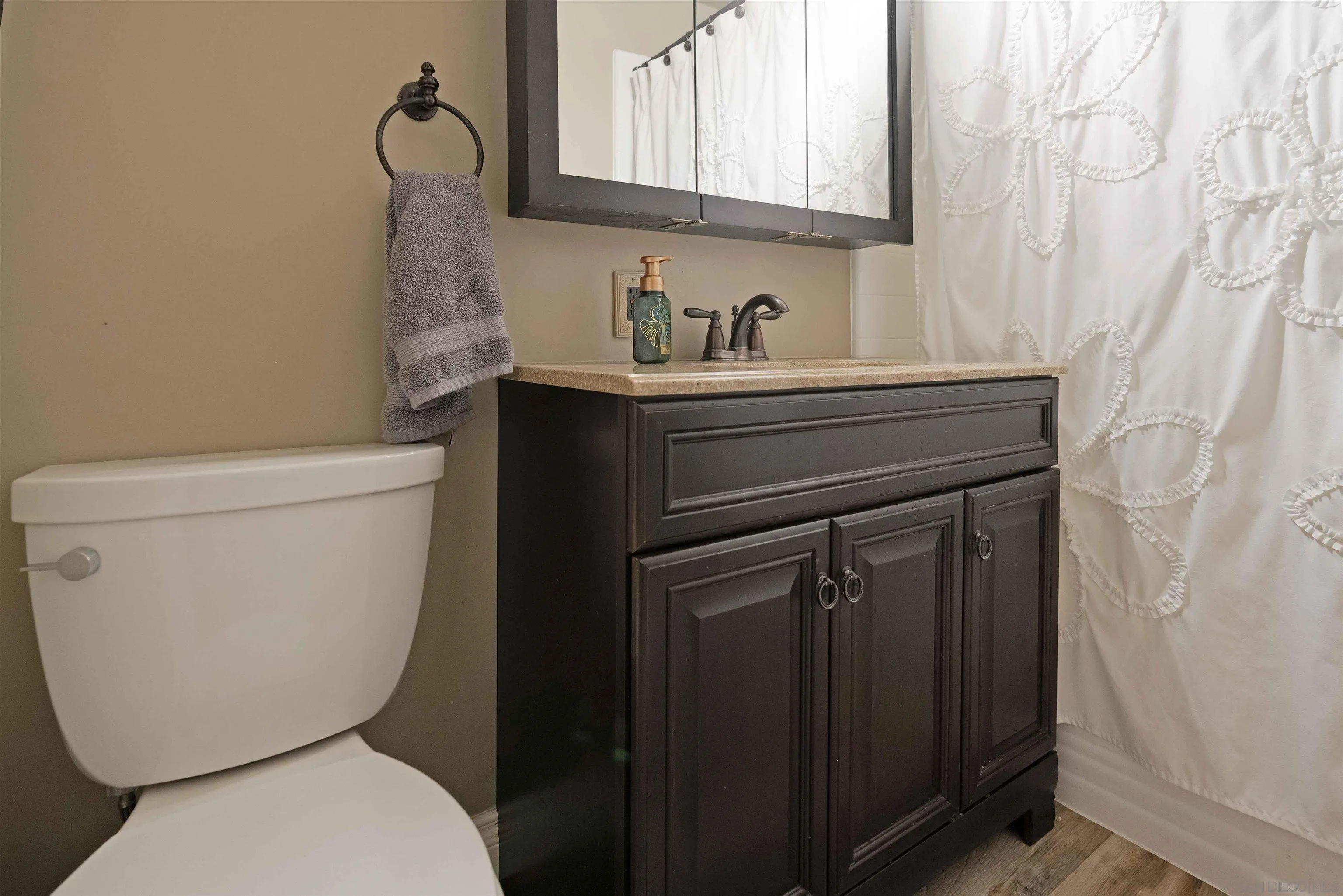 4516 Olive Avenue La Mesa, CA 91942 - Photo 26 of 48 a bathroom with a toilet sink and mirror