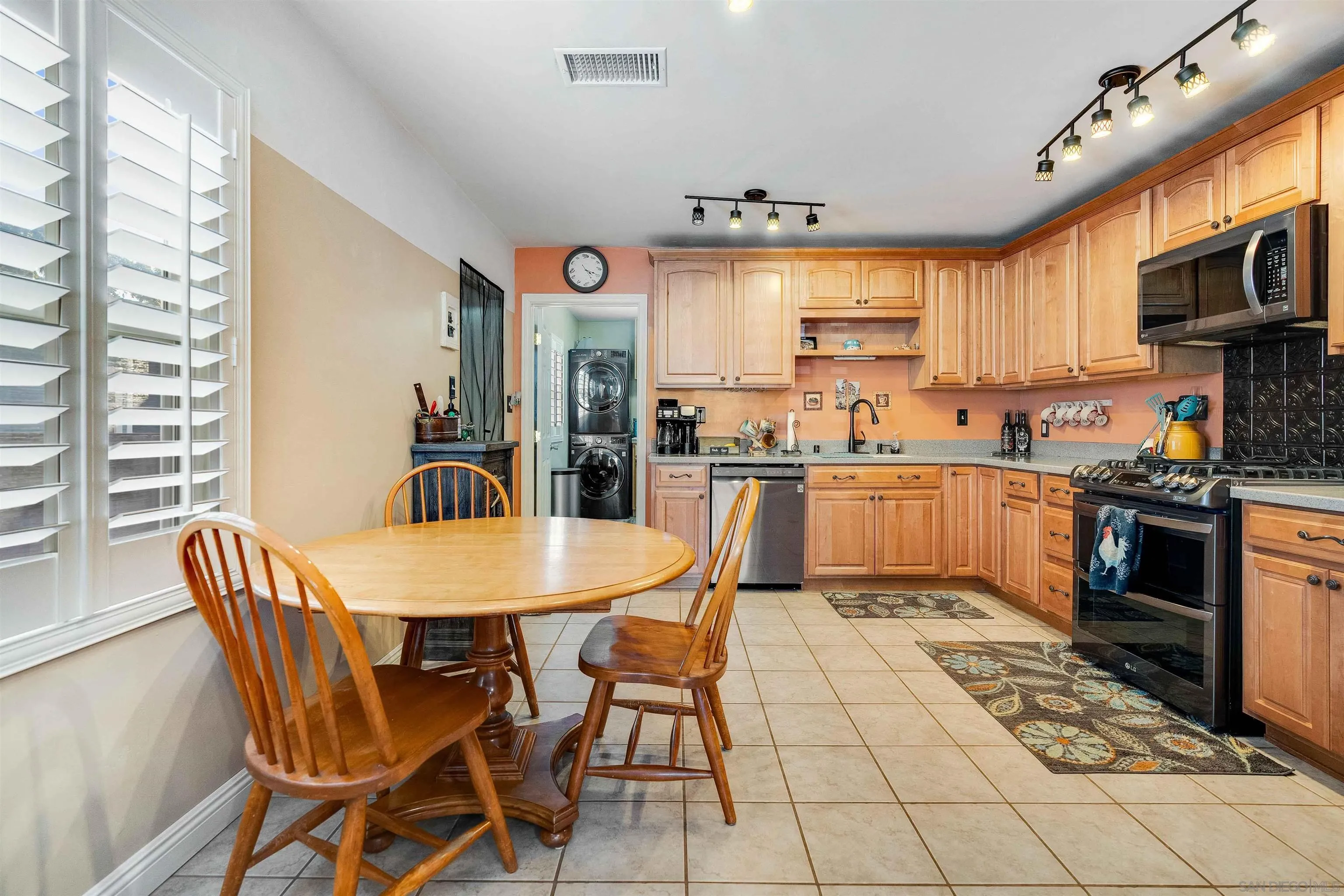 4516 Olive Avenue La Mesa, CA 91942 - Photo 5 of 48 a kitchen with stainless steel appliances granite countertop a stove a sink a microwave dining table and chairs