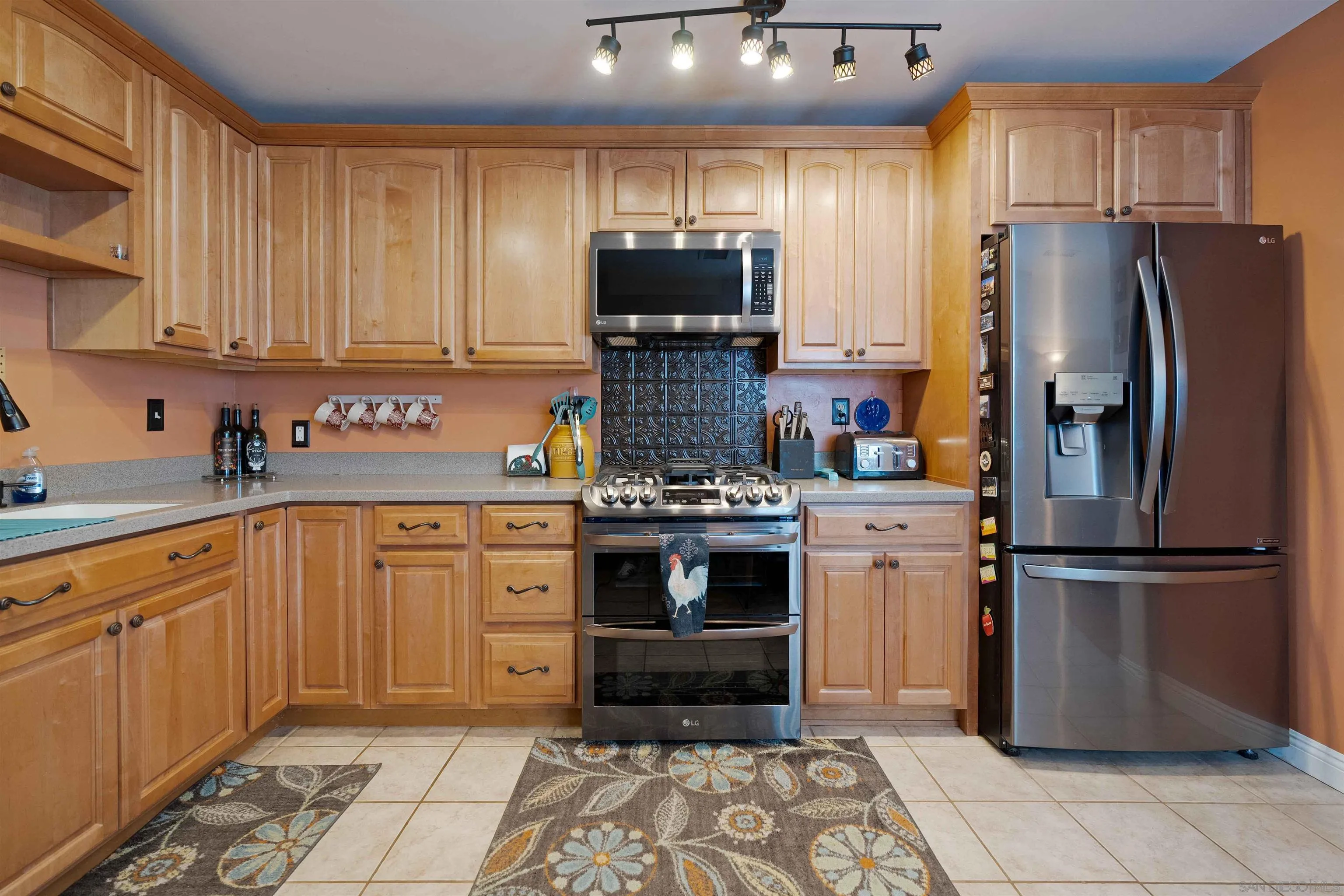 4516 Olive Avenue La Mesa, CA 91942 - Photo 10 of 48 a kitchen with stainless steel appliances granite countertop a refrigerator stove and sink