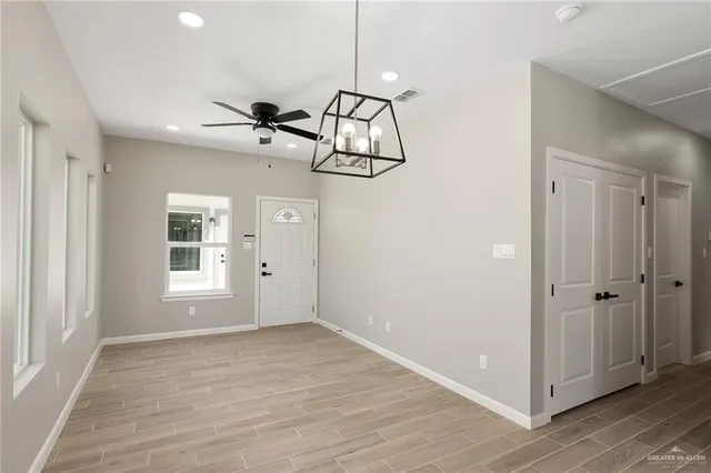 a view of a room with wooden floor and window