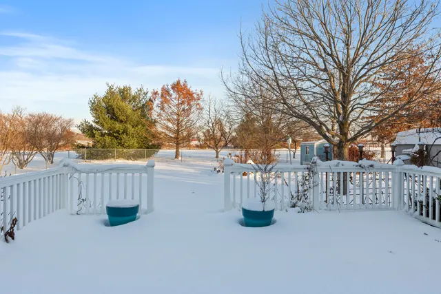 a view of house with a yard covered in snow