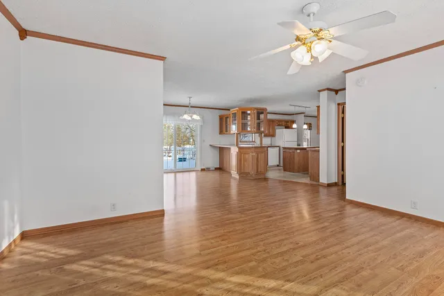 a view of a room with wooden floor and staircase