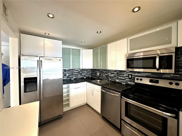 a modern kitchen with stainless steel appliances and stove