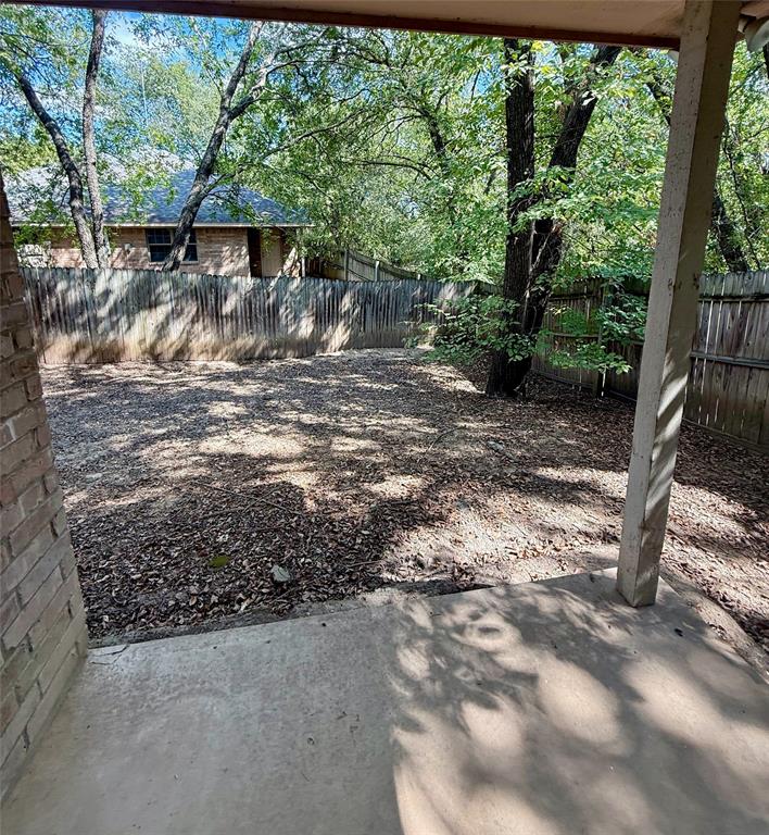954 East 3rd Street Weatherford, TX 76086 - Photo 15 of 17 a view of a yard with a tree