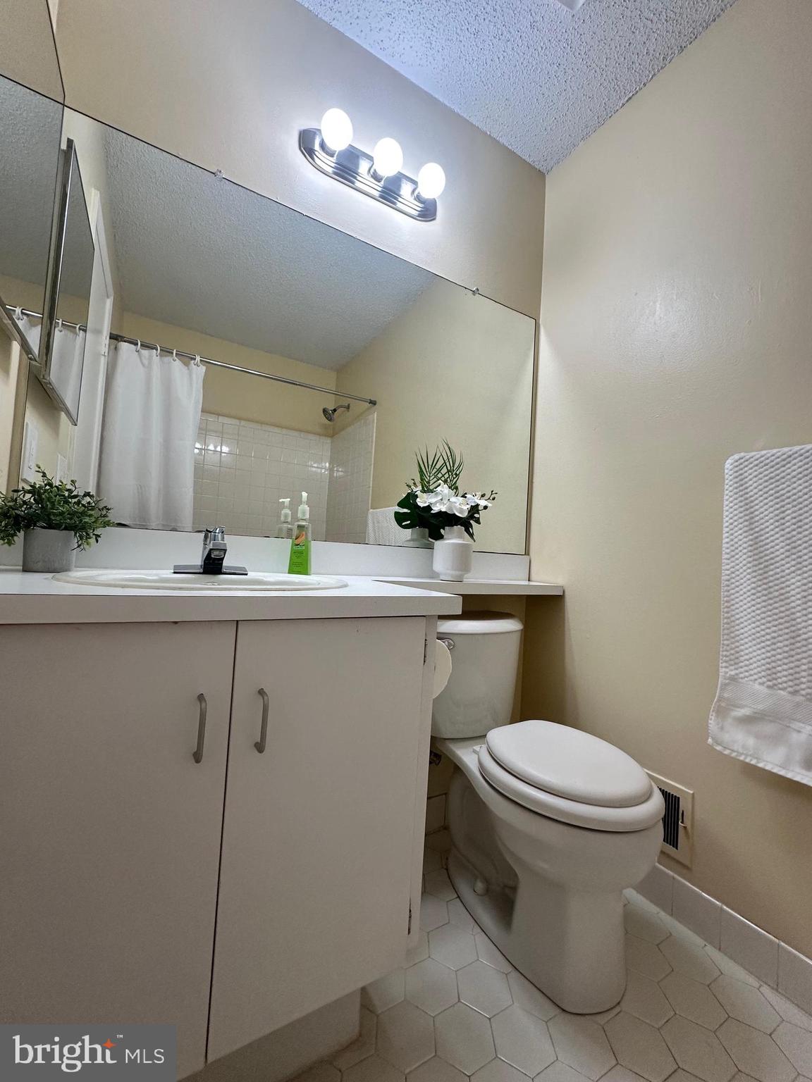 6 Wosniak Court Lawrence Township, NJ 08648 - Photo 19 of 20 a bathroom with a sink a toilet and mirror