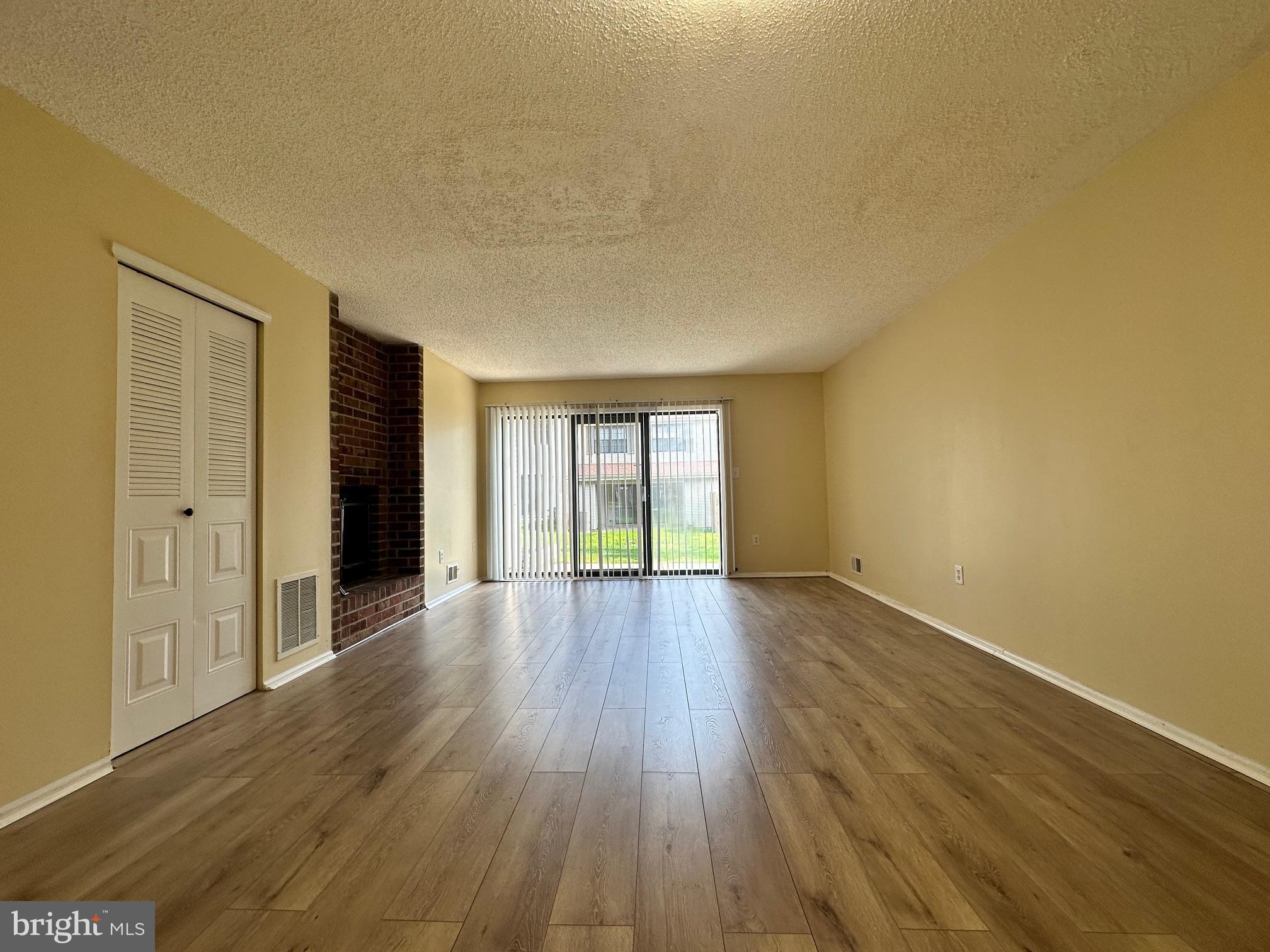 6 Wosniak Court Lawrence Township, NJ 08648 - Photo 6 of 20 a view of an empty room with wooden floor and a window