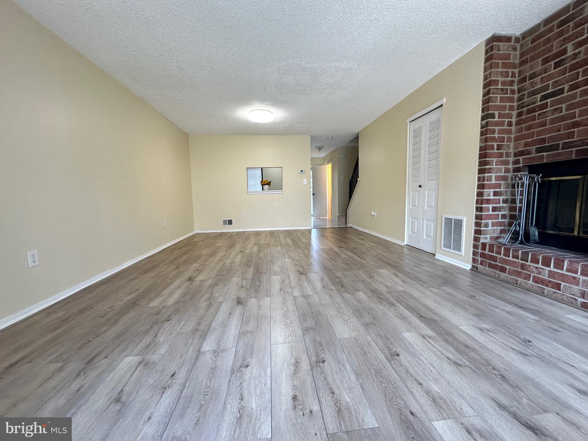 6 Wosniak Court Lawrence Township, NJ 08648 - Photo 8 of 20 a view of empty room with wooden floor and fireplace