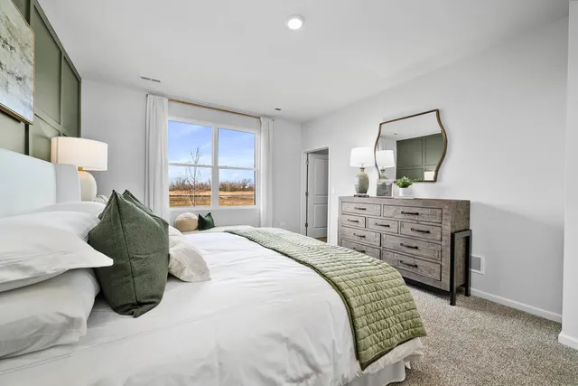 a bedroom with a bed and a dresser