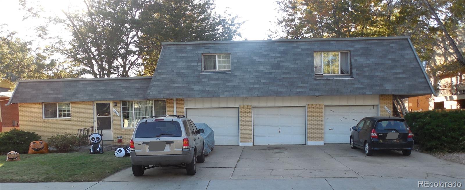a car parked in front of a brick house