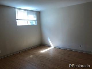 2703 Stanford Road Fort Collins, CO 80525 - Photo 11 of 30 an empty room with wooden floor and windows